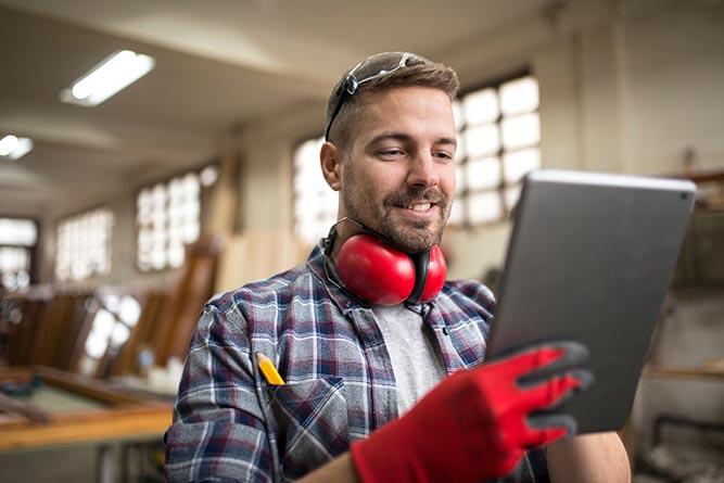 Portrait of middle aged professional worker carpenter with ear p